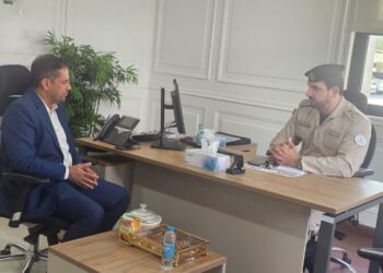 Indian Association Sharjah President Nissar Thalangara and Sharjah Police Director Dr. Saeed finalizing a labor welfare partnership agreement at the police headquarters.