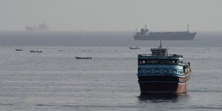Commercial cargo vessel navigating near the Strait of Hormuz maritime passage.