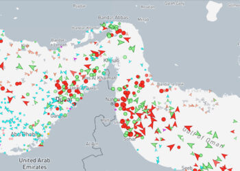 Satellite and maritime AIS traffic map showing shipping lanes in the Strait of Hormuz near Oman.