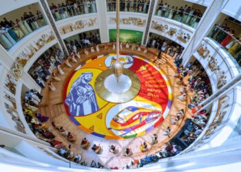 Healthcare workers at Burjeel Medical City standing around a 250-square-meter floral carpet featuring UAE President Sheikh Mohamed bin Zayed Al Nahyan.