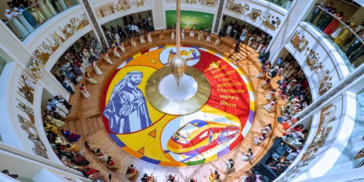 Healthcare workers at Burjeel Medical City standing around a 250-square-meter floral carpet featuring UAE President Sheikh Mohamed bin Zayed Al Nahyan.