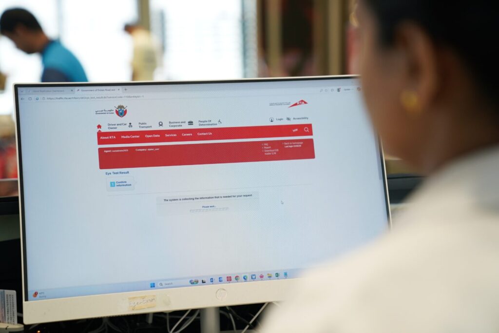 Optometrist conducting a digital eye test for a driving licence applicant in Dubai.