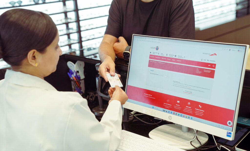 Optometrist conducting a digital eye test for a driving licence applicant in Dubai.