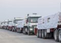 UAE humanitarian aid trucks prepared for Gaza at Al Arish logistics center.