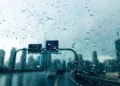 Dark rain clouds over mountainous terrain in the UAE during a summer convective shower